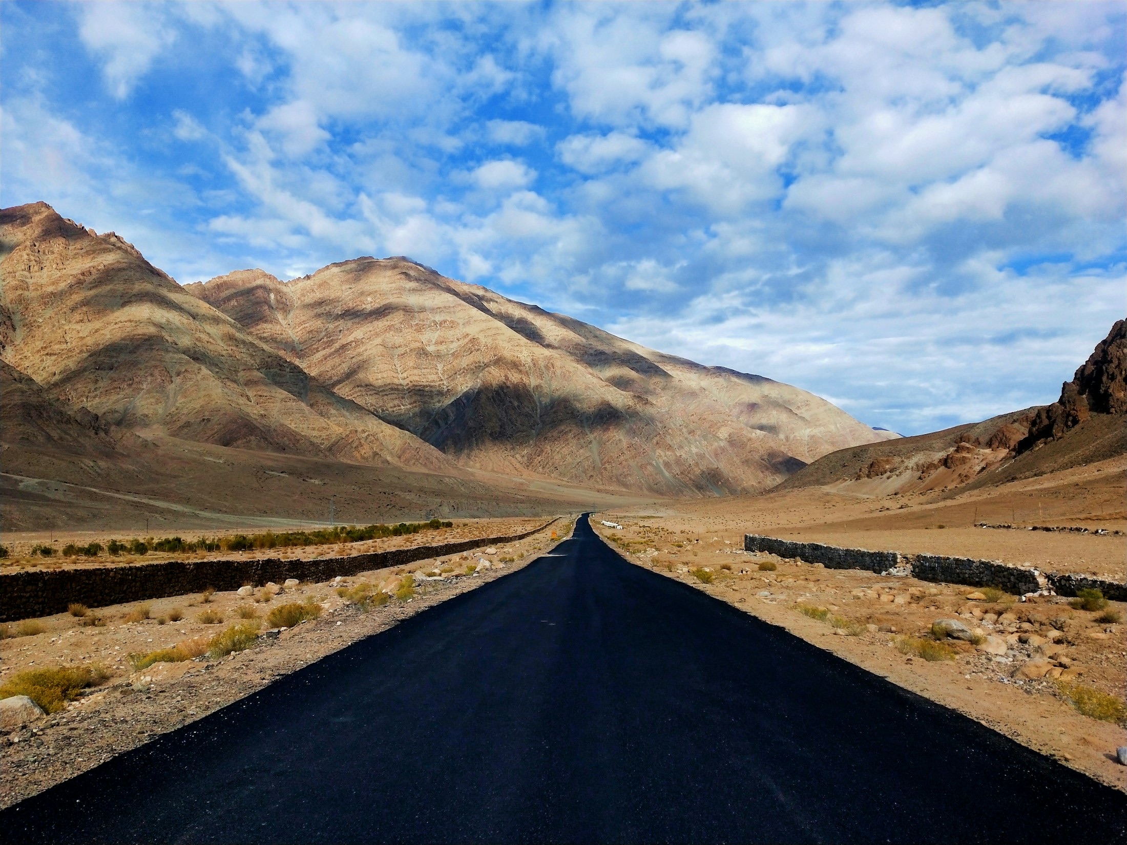 A road leading through the high mountains of Ladakh