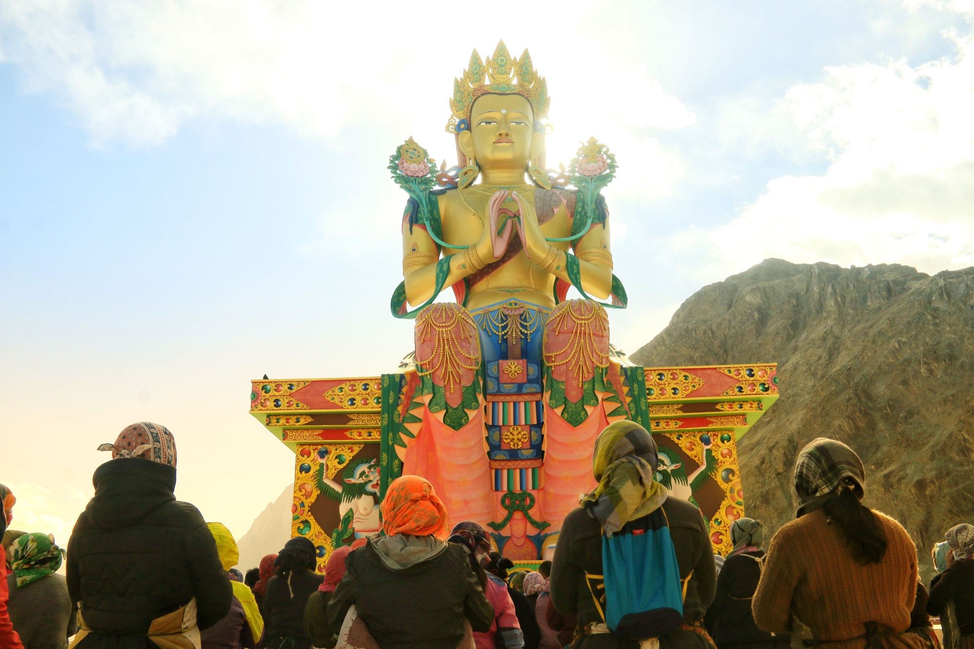 Travellers gathered beneath the Maitreya Buddha in Nubra