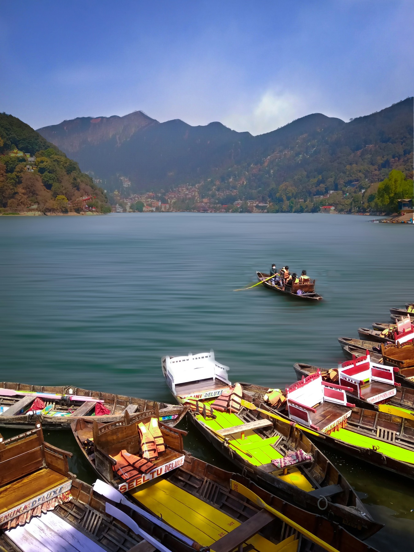 Boats crossing a mountain lake in Uttarakhand